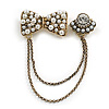 Vintage Inspired Bow and Crystal Bead Chain Brooch In Aged Gold Tone Finish